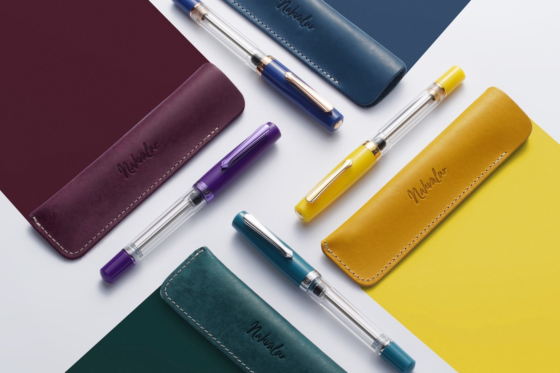 Colorful pens and their respective cases on a white background